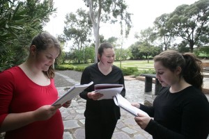 Workshop participants Lauren Townsend (left) . Jessica Harris (centre) and Bianca Riggio (right)  practice delivering their text as part of Voice and Movement workshop.